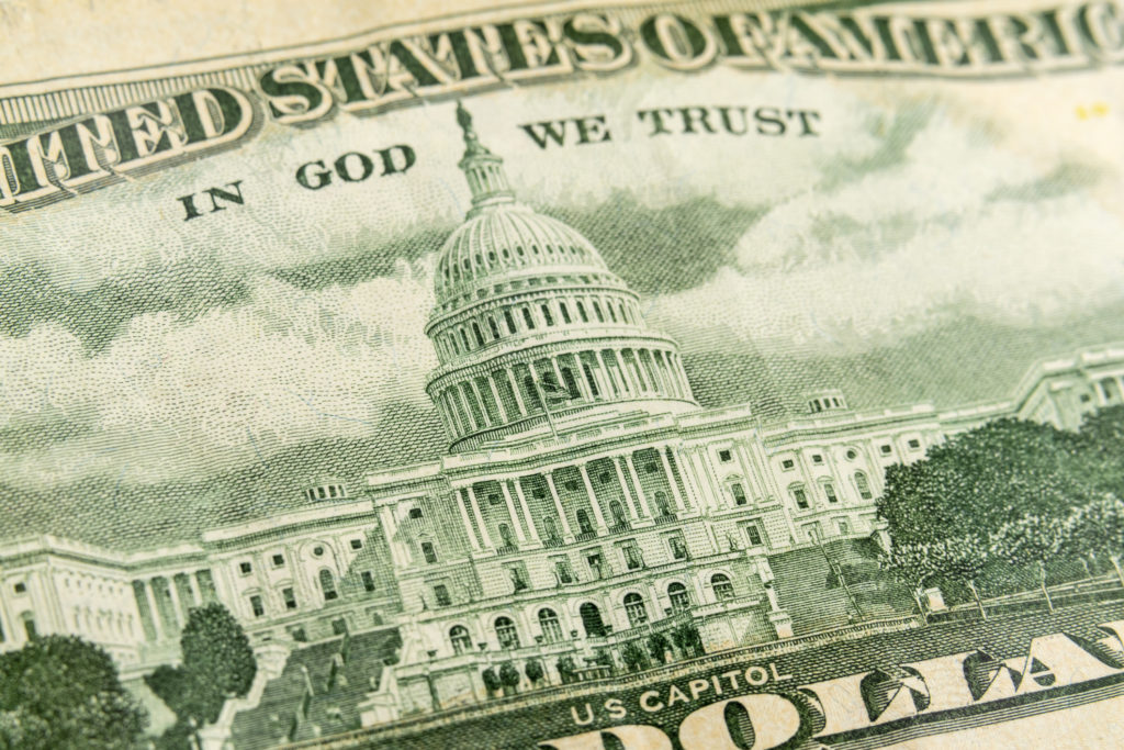 Macro photograph of the US Capitol building on back of a fifty dollar bill.