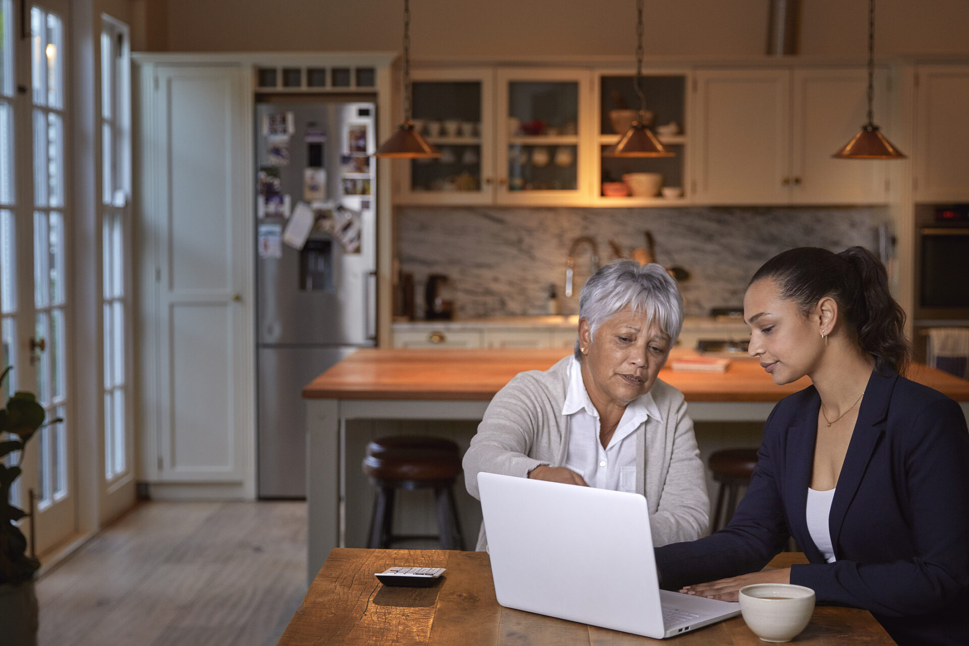 Shot of senior woman having a consultation with a financial advisor at home