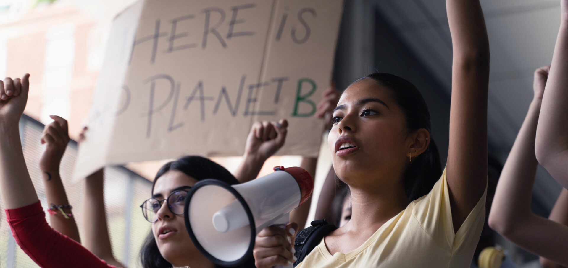 Female hispanic latin teenager students with placards and posters on global protest for climate change and Earth rights