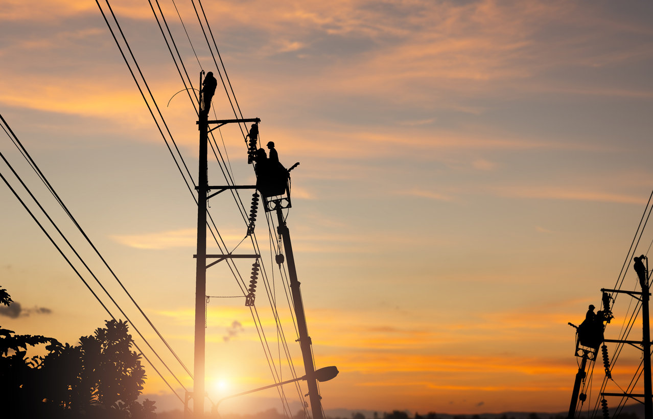 Silhouette of Electrician officer team climbs a pole and uses a cable car to maintain a high voltage line system, Shadow of Electrician lineman repairman worker at climbing work on electric post power pole